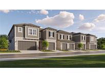 New townhome community with attached garages and lush landscaping at 18011 Orange Springs Pl, Tampa, FL 33647