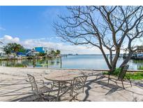 Relaxing waterfront patio with table and chairs, offering scenic views at 409 161St Ave, Redington Beach, FL 33708
