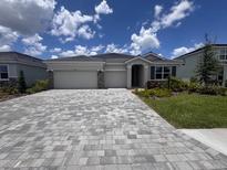 Charming single-story home boasts a paver driveway and a well-manicured lawn at 4314 Pullet Ct, Lakewood Ranch, FL 34211