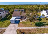 Aerial view of a single-Gathering home with a large backyard and waterfront access at 4610 Bay Crest Dr, Tampa, FL 33615