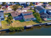 Aerial view showcasing a single-Gathering home's backyard and canal-front location at 4610 Bay Crest Dr, Tampa, FL 33615