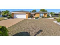 House exterior with a single-car garage and manicured landscaping at 703 Elkhorn Rd, Sun City Center, FL 33573