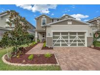 Two-story house with landscaped yard and two-car garage at 8272 Artisan Way, Seminole, FL 33777