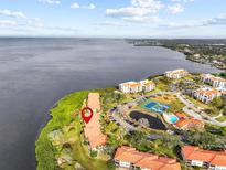 Aerial view of waterfront community with tennis courts and pool at 1814 Mariner Dr # 159, Tarpon Springs, FL 34689