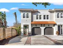Two-story townhome with attached garage and a brick walkway at 216 S Westland Ave # 4, Tampa, FL 33606
