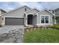 Curb appeal abounds in this charming one-story home, featuring a two-car garage and attractive landscaping at 36159 Welsh Glade Rd, Dade City, FL 33525