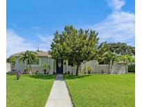 Charming single-story home with a well-manicured lawn and walkway at 601 42Nd Ne Ave, St Petersburg, FL 33703