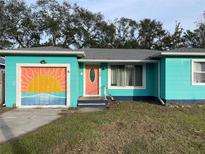 Charming teal house with painted garage and steps leading to the entrance at 2716 49Th S St, Gulfport, FL 33707