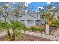 Gray house with two-car garage and landscaped yard at 6831 S Wall St, Tampa, FL 33616