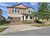Two-story home with attached garage and landscaped front yard at 9928 Ivory Dr, Ruskin, FL 33573