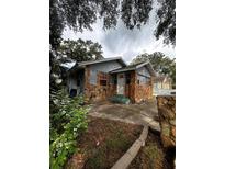 Ranch style home with stone facade and mature landscaping at 2011 Auburn S St, St Petersburg, FL 33712