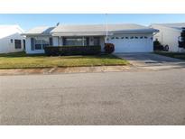Charming single-story home featuring a well-maintained lawn and attached two-car garage at 9157 42Nd N Way, Pinellas Park, FL 33782