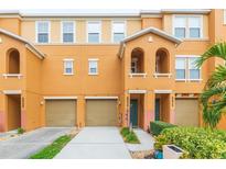 Front view of a two-story townhome with a tan facade and attached garage at 9024 White Sage Loop # 37, Lakewood Ranch, FL 34202