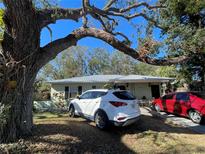Ranch-style home with carport, mature trees, and spacious yard at 2221 York S St, Gulfport, FL 33707