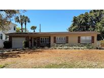 Charming single-story home with brick accents, shutters, and a well-manicured lawn at 3613 S Omar Ave, Tampa, FL 33629