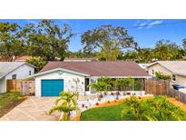 Attractive single-story home with teal garage door and landscaped yard at 5529 11Th N Ave, St Petersburg, FL 33710