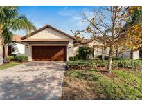 Attractive single-story home with a two-car garage and landscaped yard at 16820 Anchor Root St, Wimauma, FL 33598