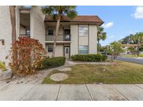 Inviting condo exterior, featuring landscaping and a private entrance at 2750 E Bay Dr # 15E, Largo, FL 33771