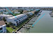 A row of waterfront townhomes with private docks and boat slips in a coastal community at 322 Windrush Blvd # 2, Indian Rocks Beach, FL 33785