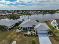 Beautiful waterfront home with meticulously maintained landscaping and a private lake view at 407 Blackhawk Cir, Sun City Center, FL 33573