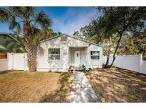 Charming single-story home with a white exterior and a well-maintained lawn at 601 Paris S Ave, St Petersburg, FL 33701