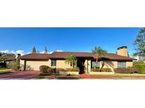 Single-story house with brown roof, red brick driveway, and palm trees at 702 Dorado Ct, Brandon, FL 33511