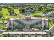 Aerial view of a condo building with golf course and water views at 8950 Park Blvd # 505, Seminole, FL 33777