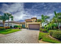Single story home with tile roof and paver driveway, nicely landscaped at 13118 Sorrento Way, Bradenton, FL 34211