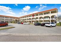 Two-story condo building with parking and landscaped grounds at 2434 Australia E Way # 42, Clearwater, FL 33763