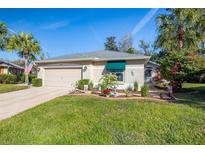 Single-story house with attached garage and well-manicured lawn at 11116 Jenkins Ct, San Antonio, FL 33576