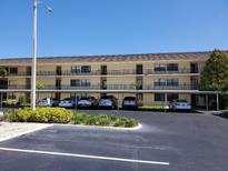 Condo building with covered parking and landscaping at 12300 Vonn Rd # 6103, Largo, FL 33774