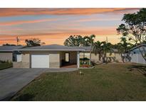 Charming single story home with a well-manicured lawn and attached garage at 13511 87Th Pl, Seminole, FL 33776