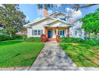 Charming two-story home with brick accents and a manicured lawn at 2433 W Watrous Ave, Tampa, FL 33629