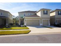 Two-story house with two-car garage and landscaped front yard at 3000 Jacob Crossing Ln, Holiday, FL 34691