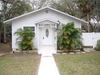 Charming white bungalow with landscaped front yard and walkway at 420 5Th N St, Safety Harbor, FL 34695