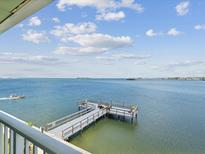 Expansive water view featuring a dock and clear skies for a relaxing waterfront experience at 464 N Paula Dr # 322, Dunedin, FL 34698
