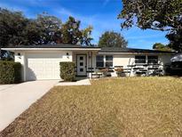 Charming single-story home with a well-manicured lawn and attached garage, perfect for suburban living at 7521 Bougenville Dr, Port Richey, FL 34668