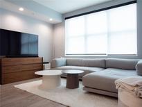 Bright living room featuring a comfortable sectional sofa, modern furniture, and large window at 1120 E Kennedy Blvd # 1225, Tampa, FL 33602