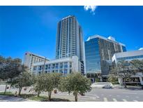 Modern high-rise building with city views and tree-lined street at 301 1St S St # 1005, St Petersburg, FL 33701