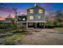 Charming two-story home with a spacious carport and a screened in porch, perfect for outdoor relaxation at 4501 Keene Rd, Plant City, FL 33565