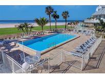 Relaxing community pool with lounge chairs and easy beach access offering an idyllic coastal living experience at 17980 Gulf Blvd # 103, Redington Shores, FL 33708