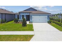 Charming one-story home featuring a well-manicured lawn and a two-car garage at 4202 Big Sky Dr, Spring Hill, FL 34604