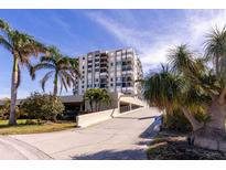 High-rise building with palm trees and parking area at 6372 Palma Del Mar S Blvd # 705, St Petersburg, FL 33715