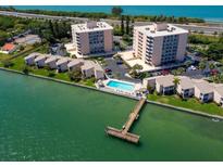 Aerial view of waterfront community with pool and private dock at 7432 Sunshine Skyway S Ln # 402, St Petersburg, FL 33711