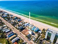 Stunning aerial view of beachfront property, showcasing its prime location along the pristine shoreline and turquoise waters at 820 Gulf Blvd # S 1-3, Indian Rocks Beach, FL 33785
