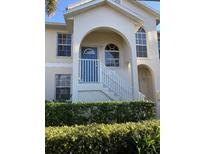 Two-story condo building with a manicured front yard and a charming entrance at 4220 Players Pl # 2221, Sarasota, FL 34238