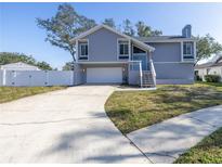 Newly renovated two-story home with attached garage and landscaped yard at 9446 Laura Anne Dr, Seminole, FL 33776