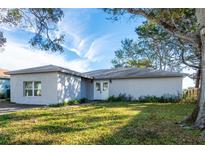 Single story home with front yard and mature trees at 12417 84Th Way, Largo, FL 33773