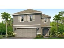 Two-story house with gray siding, shutters, and a two-car garage at 5017 Rocky Coast Pl, Palmetto, FL 34221