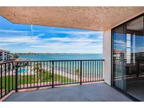 Enjoy stunning waterfront views from this condo balcony, overlooking the pool and tranquil beach at 6145 Sun Blvd # 607, St Petersburg, FL 33715